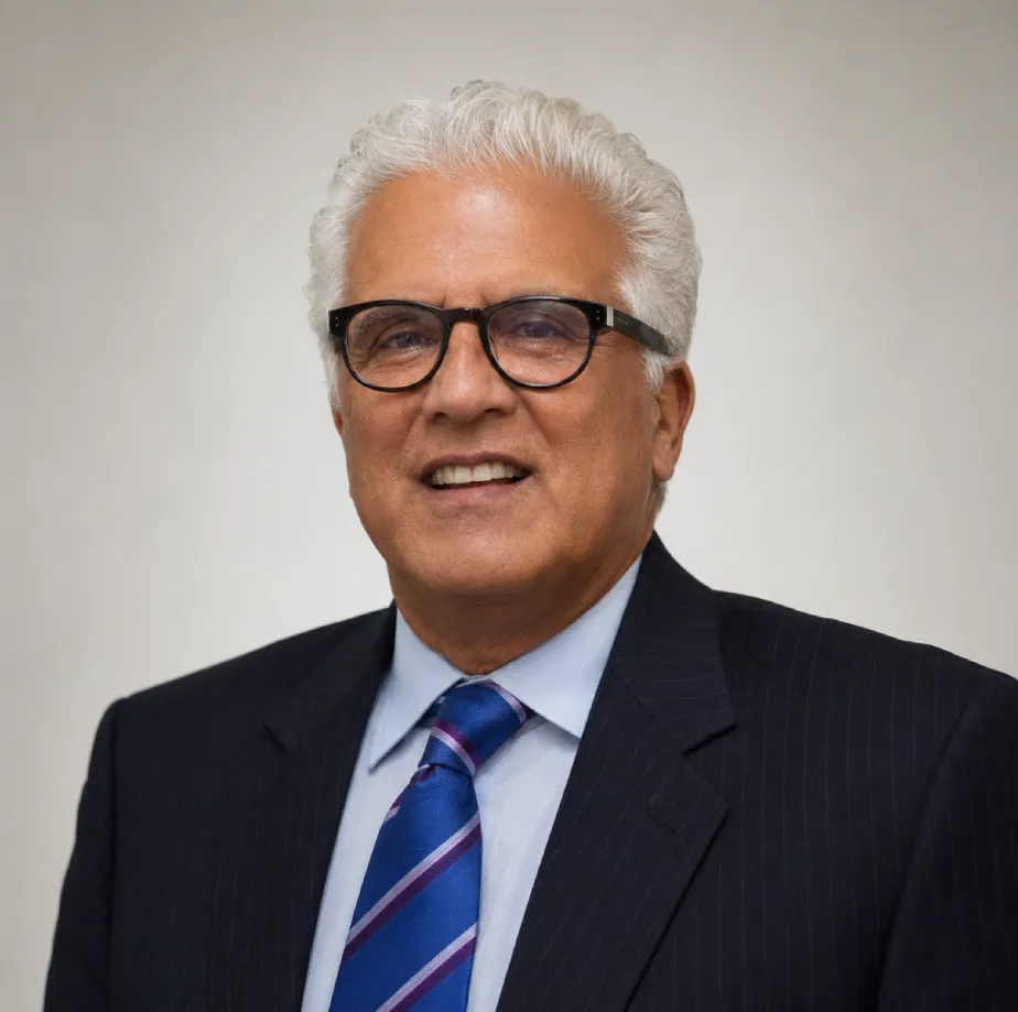 Portrait of Bruce A. Dobish — silver hair, dark-rimmed glasses, navy pinstripe suit and blue striped tie
